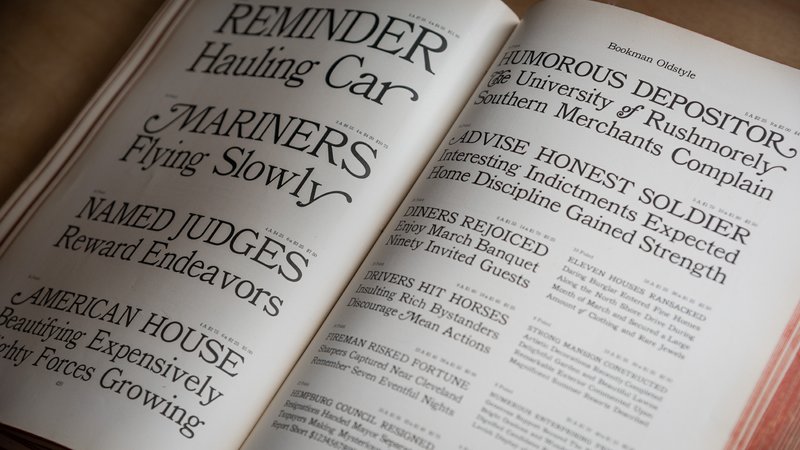 The 1912 American Type Founders catalog rests open to a spread showing the typeface Bookman Oldstyle