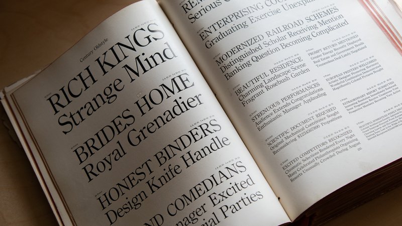The 1912 American Type Founders catalog rests open to a spread showing the typeface Century Oldstyle
